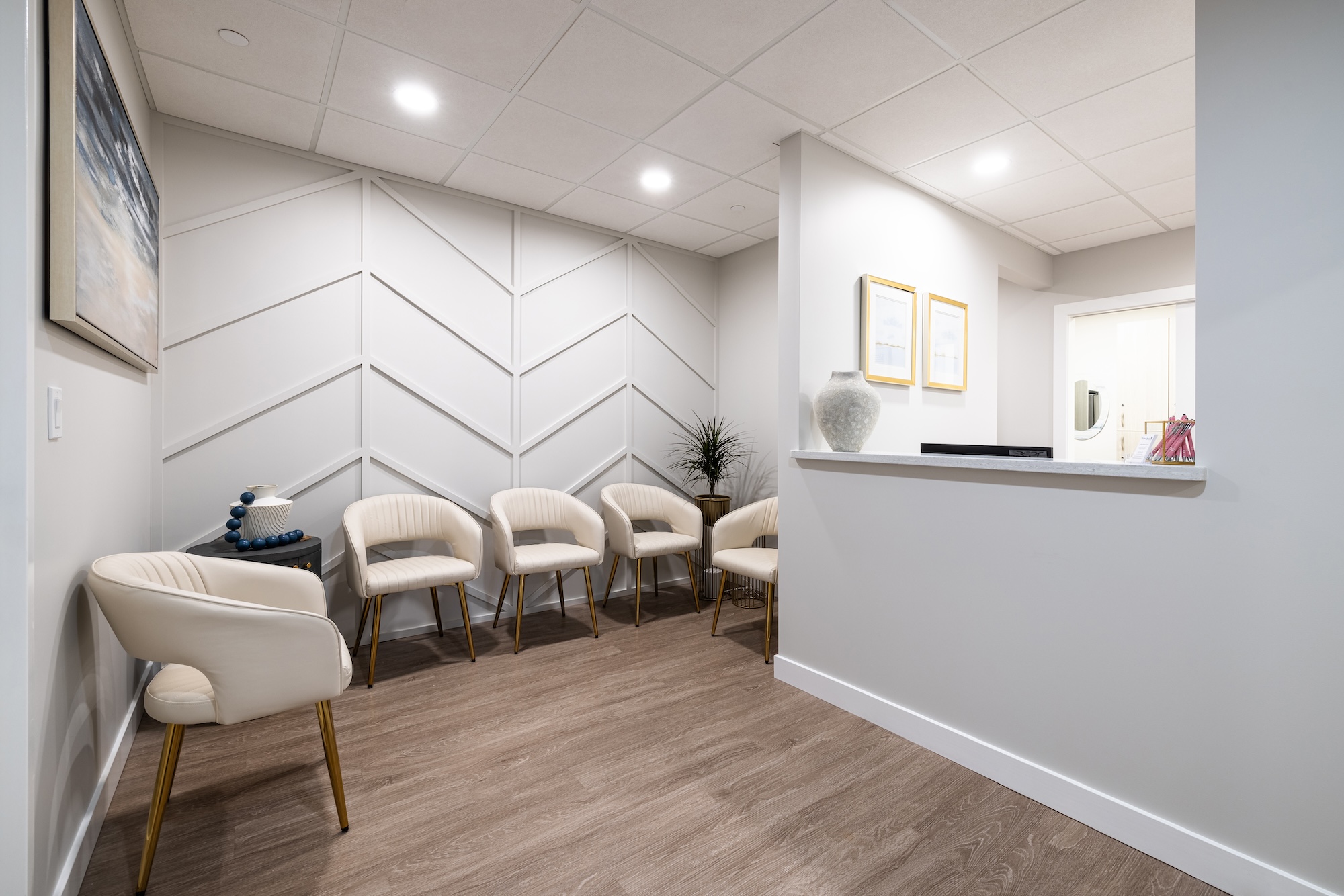 The image shows an interior space that appears to be a waiting room or lobby, with modern furnishings and decor.