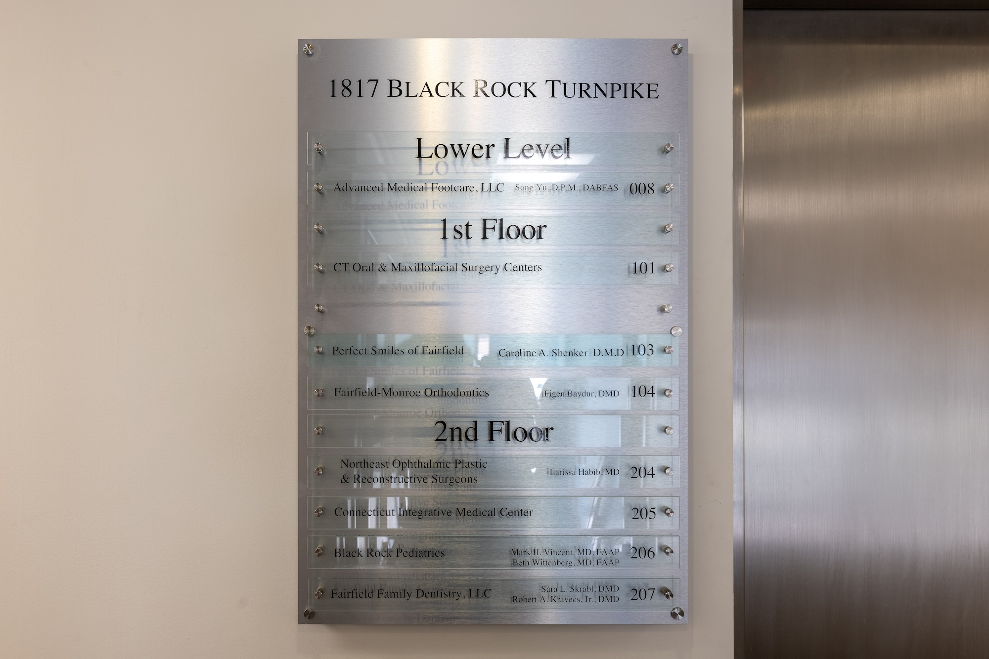 The image shows a sign with text providing information about a location, including the name of an establishment and its address.