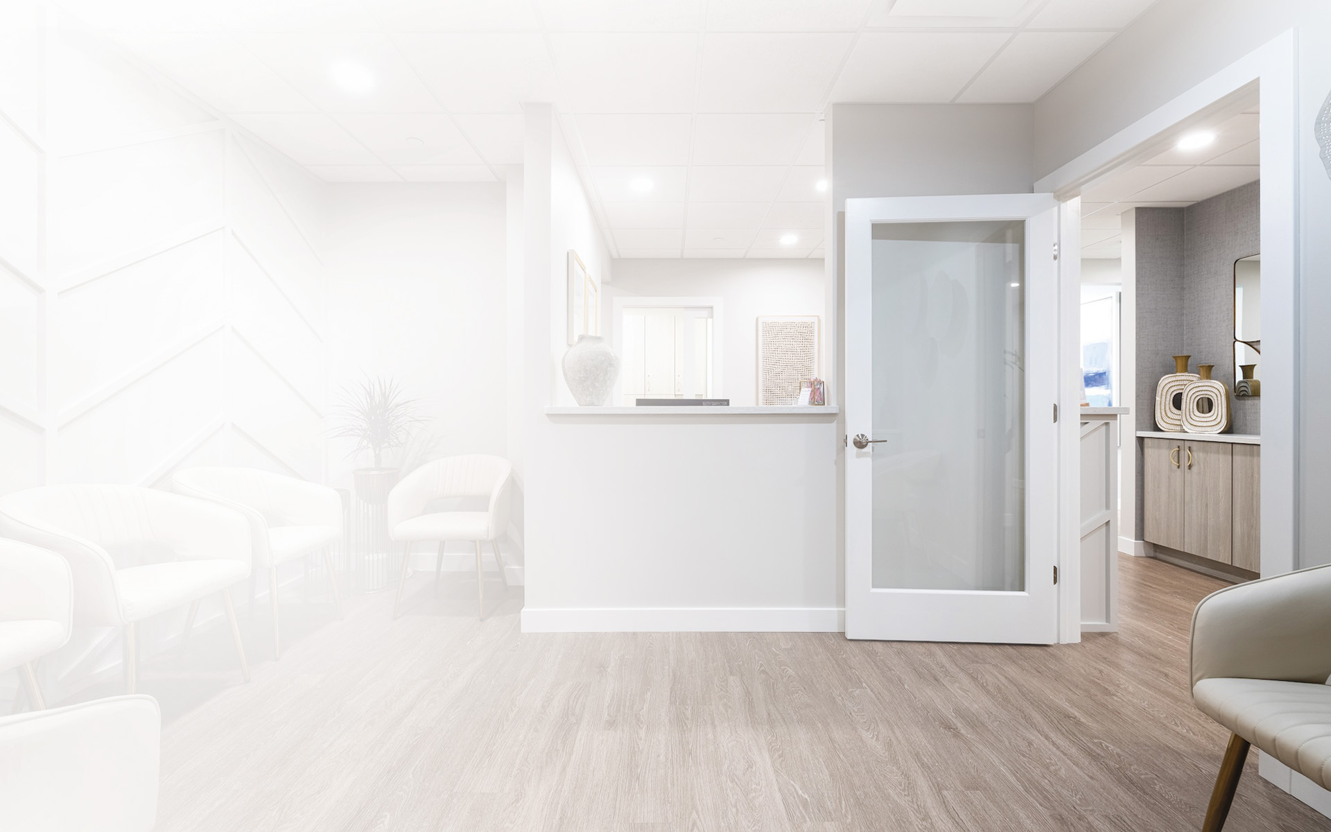 A modern dental practice with a blue and white chair, a dental treatment table, and medical equipment.