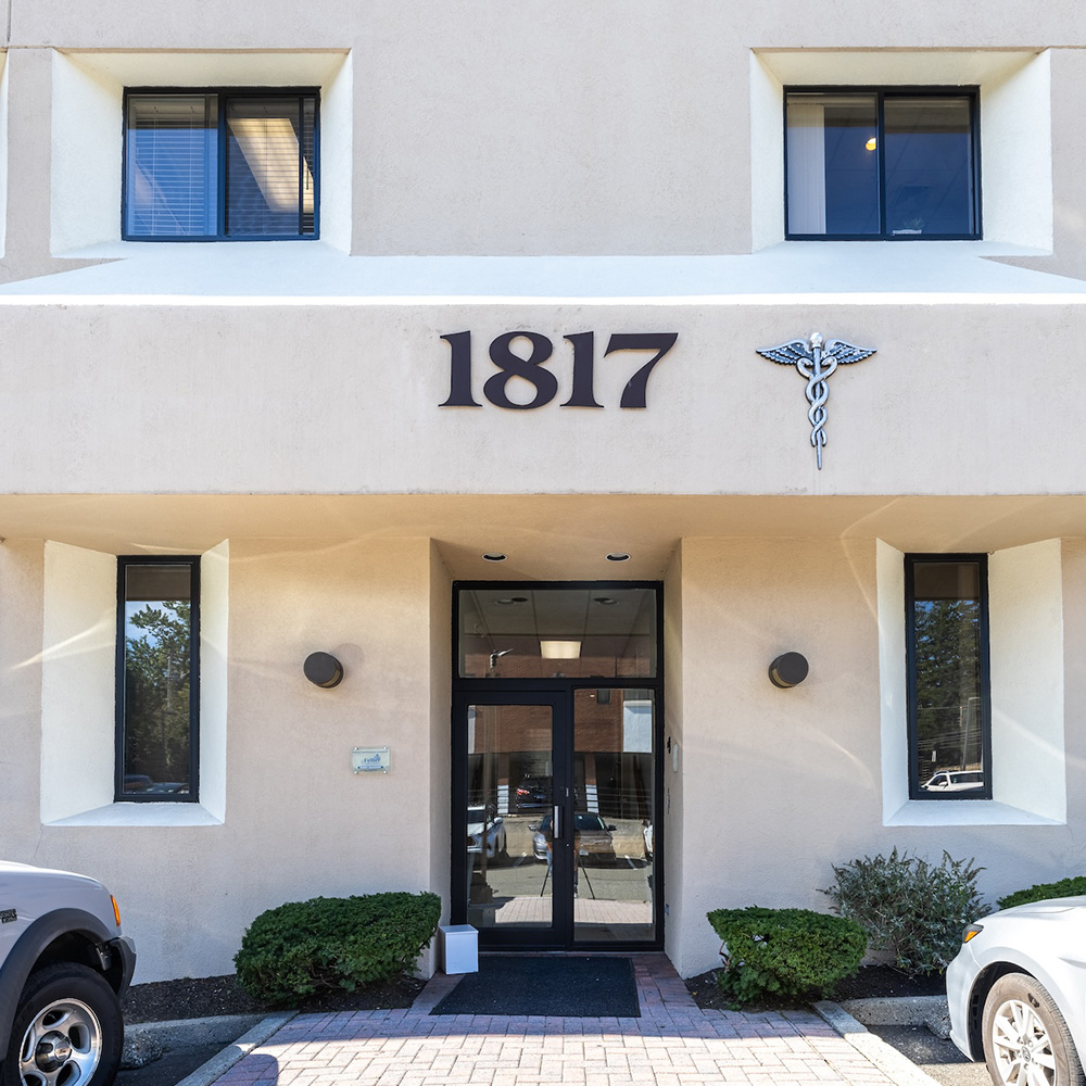 The image shows a building with a sign that reads  1817  and a logo resembling a medical cross, indicating it may be a healthcare facility.